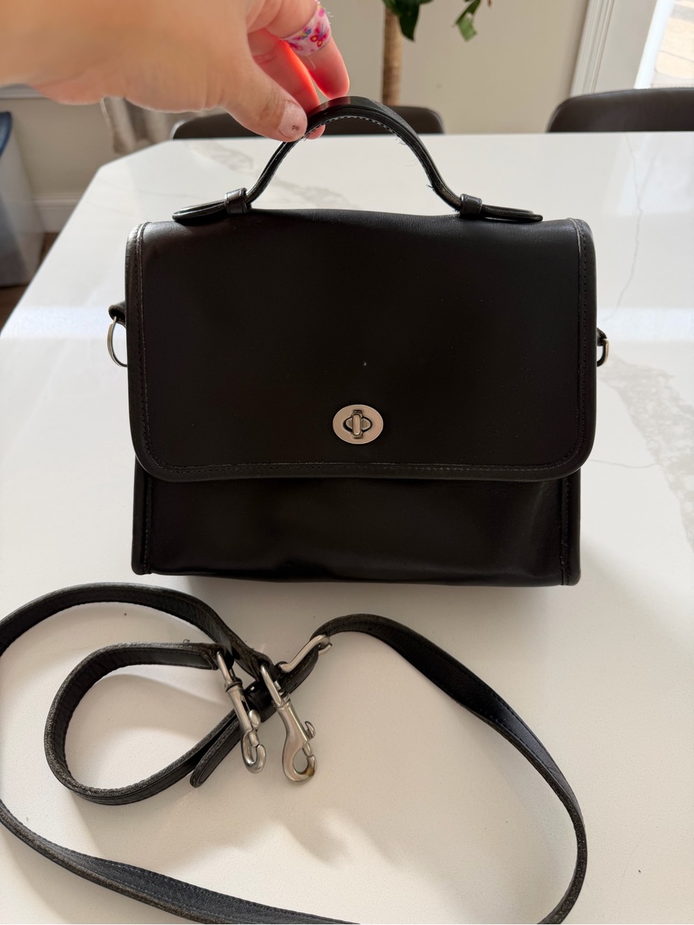 Coach Court Bag in black glovetanned leather with silver-tone hardware.